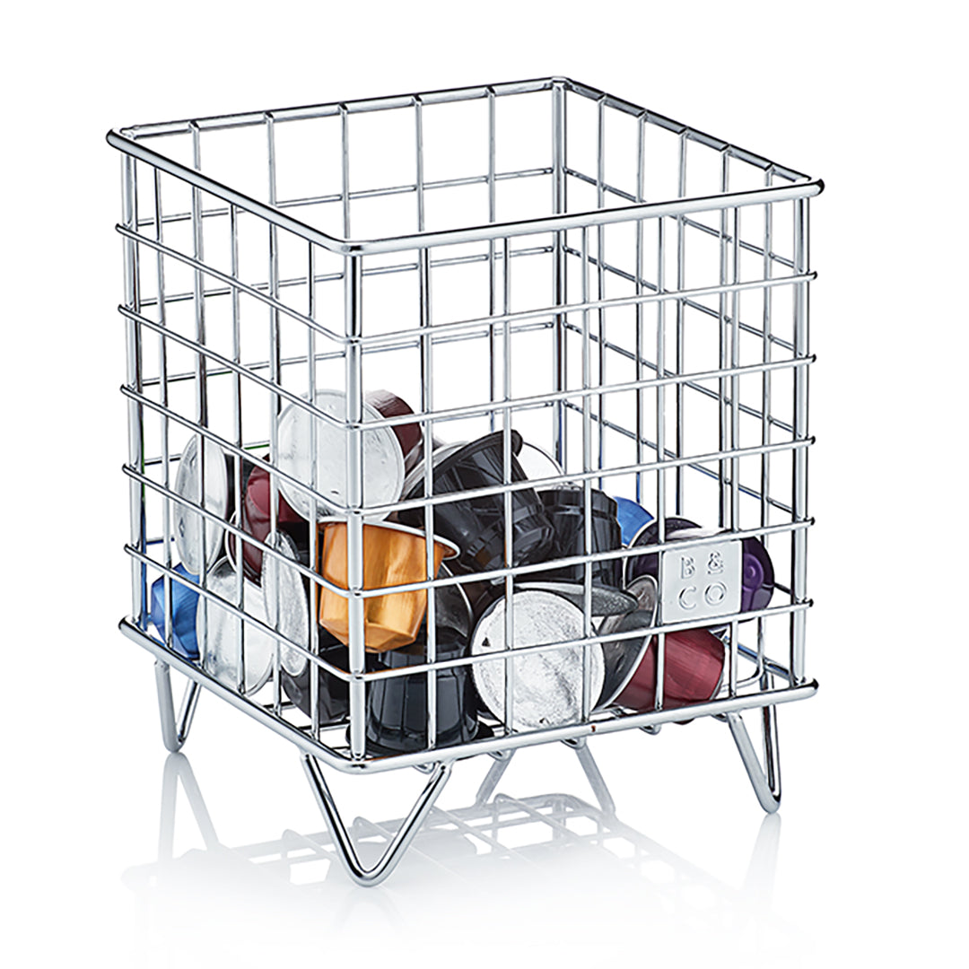 Coffee pods in storage basket on white background