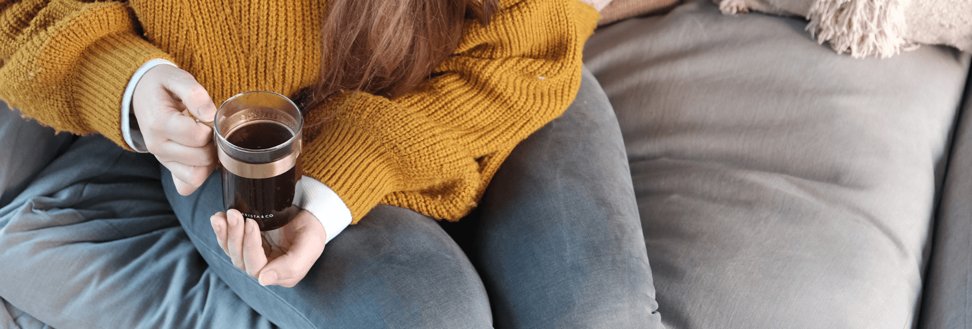 woman drinking fresh coffee on the sofa