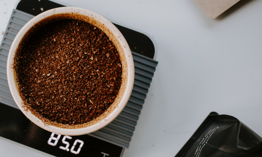 Fresh ground coffee with coffee grinder from whole bean